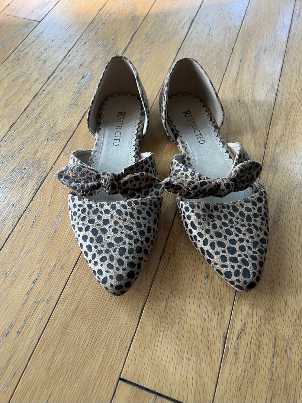 Restricted Beige and Black D'Orsay Pointed Flats with Bow Accent